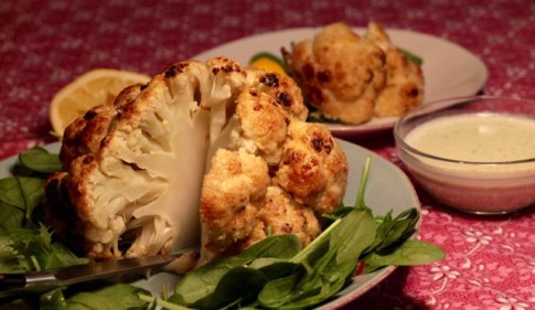 Whole, roasted cauliflower with preserved lemon yogurt sauce