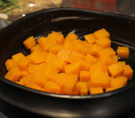 Butternut squash cubes in buttered gratin dish